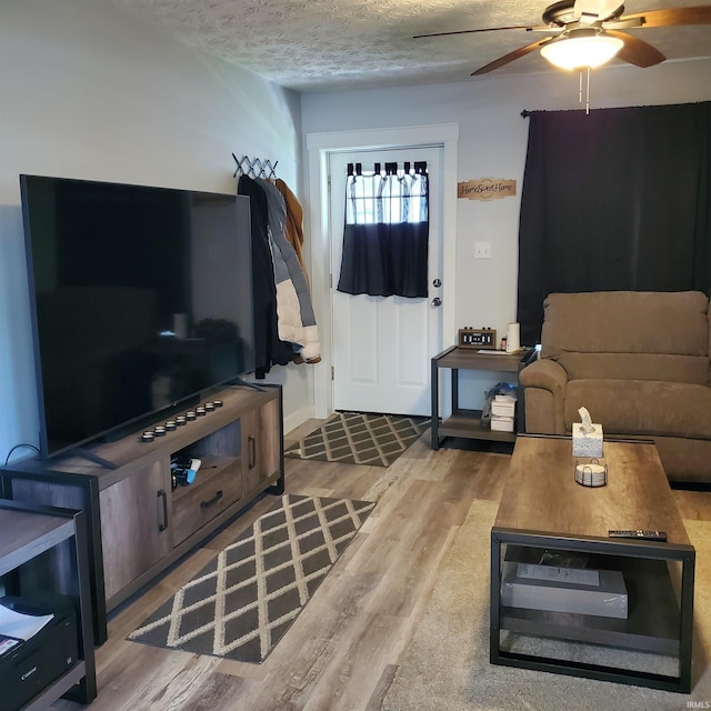 1202 Magnolia Ave, Frankfort, IN 46401 - living area with wood finished floors, ceiling fan, and a textured ceiling