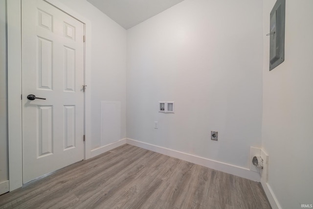washroom featuring hookup for an electric dryer, wood finished floors, hookup for a washing machine, baseboards, and electric panel