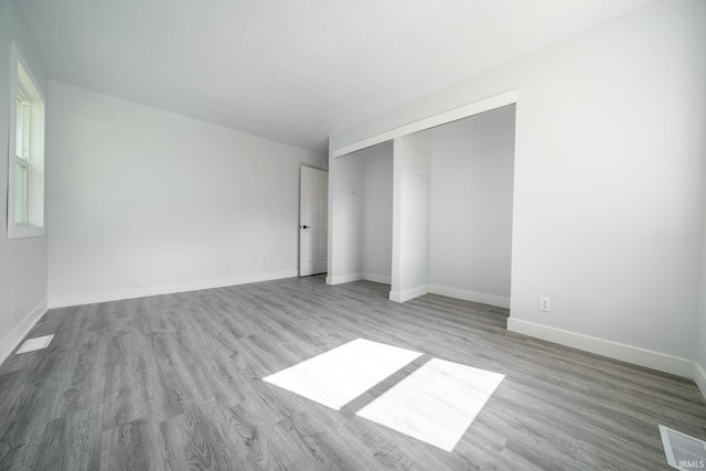 empty room featuring wood finished floors and baseboards