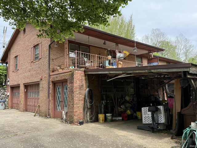 view of building exterior featuring driveway and an attached garage