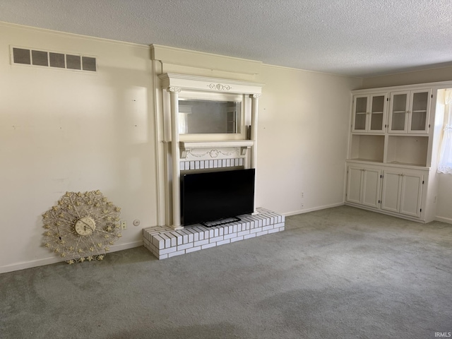 unfurnished living room with light colored carpet, a textured ceiling, and baseboards