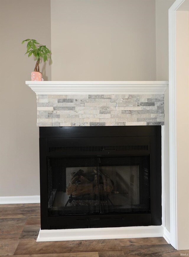 7001 Sweet Gum Ct, Fort Wayne, IN 46804 - detailed view of a stone fireplace, baseboards, and wood finished floors