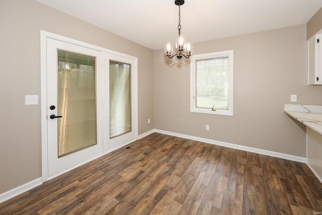 7001 Sweet Gum Ct, Fort Wayne, IN 46804 - unfurnished dining area featuring a chandelier, dark wood-style floors, and baseboards