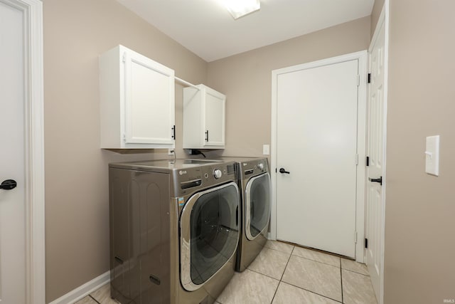 7001 Sweet Gum Ct, Fort Wayne, IN 46804 - laundry area with separate washer and dryer, cabinet space, light tile patterned floors, and baseboards