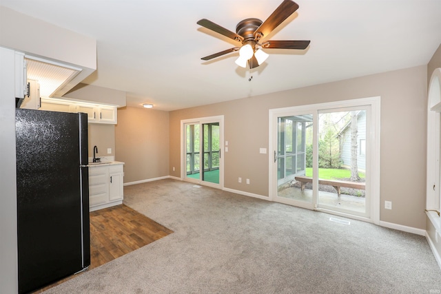 7001 Sweet Gum Ct, Fort Wayne, IN 46804 - kitchen featuring freestanding refrigerator, a ceiling fan, white cabinets, baseboards, and carpet floors