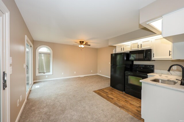 7001 Sweet Gum Ct, Fort Wayne, IN 46804 - kitchen featuring black appliances, a sink, light carpet, a ceiling fan, and baseboards