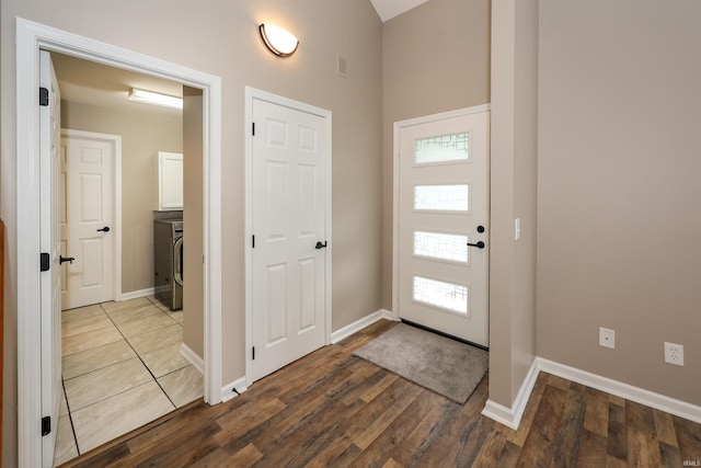 7001 Sweet Gum Ct, Fort Wayne, IN 46804 - entrance foyer featuring baseboards, wood finished floors, washer / clothes dryer, and high vaulted ceiling