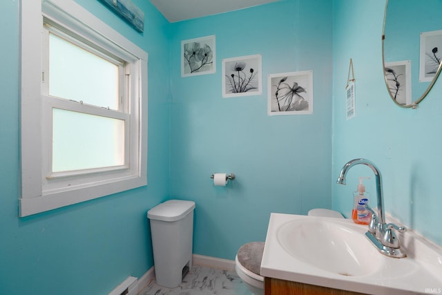 bathroom featuring toilet, baseboards, marble finish flooring, vanity, and a baseboard radiator