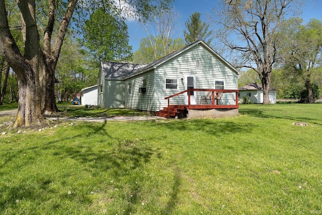 back of property featuring a wooden deck and a yard