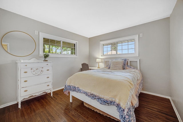 bedroom featuring baseboards and wood finished floors