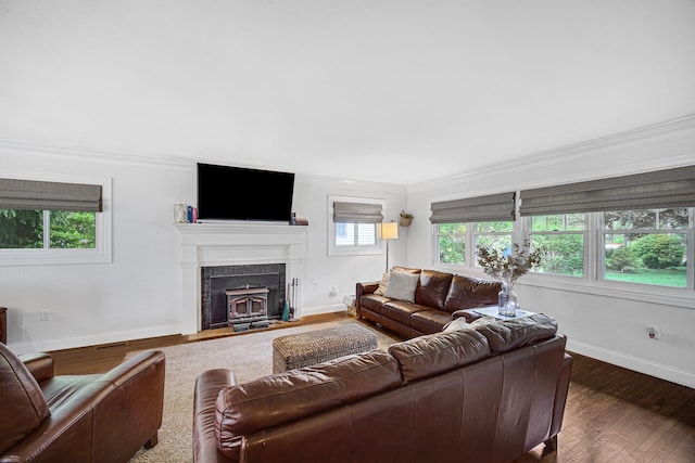 living room featuring baseboards, ornamental molding, and wood finished floors