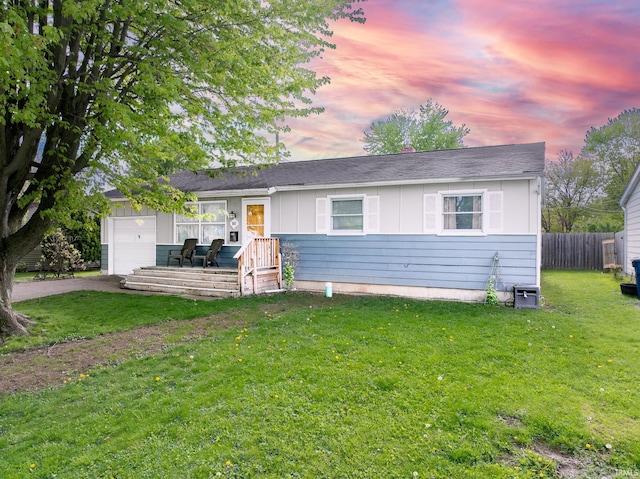ranch-style home featuring asphalt driveway, board and batten siding, and an attached garage