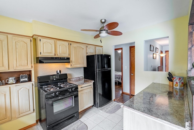 kitchen featuring black appliances, under cabinet range hood, ceiling fan, tasteful backsplash, and light tile patterned floors