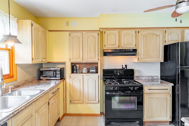 kitchen with black appliances, under cabinet range hood, a sink, a ceiling fan, and light tile patterned floors