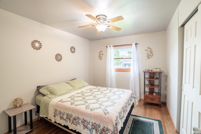 bedroom with wood finished floors, ceiling fan, and baseboards