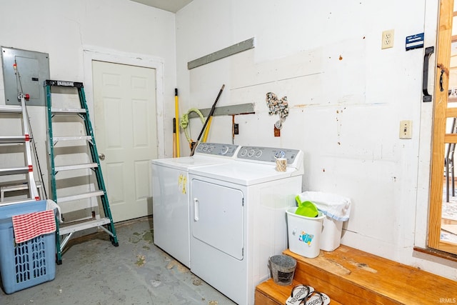 clothes washing area with washing machine and dryer and electric panel