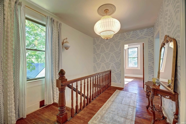 489 S Lincoln St, Orleans, IN 47452 - corridor with an upstairs landing, baseboards, wood finished floors, and wallpapered walls