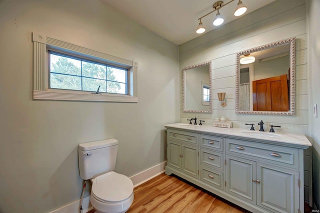 489 S Lincoln St, Orleans, IN 47452 - full bath with baseboards, toilet, wood finished floors, and double vanity