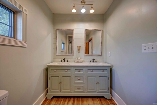 489 S Lincoln St, Orleans, IN 47452 - full bath with wood finished floors, baseboards, and toilet