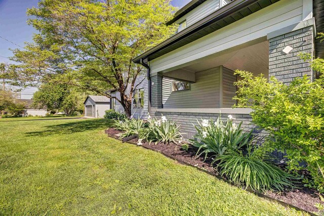 489 S Lincoln St, Orleans, IN 47452 - view of property exterior with a lawn and brick siding
