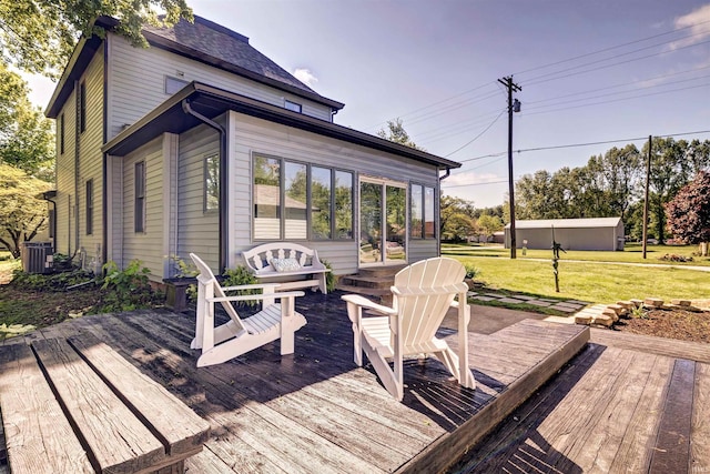 489 S Lincoln St, Orleans, IN 47452 - wooden terrace featuring a lawn, an outdoor hangout area, and central AC unit