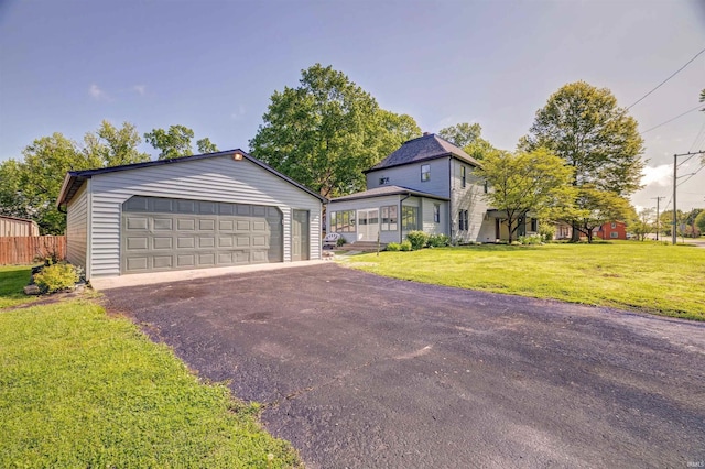 489 S Lincoln St, Orleans, IN 47452 - view of front of house with an outdoor structure, a front yard, and a detached garage