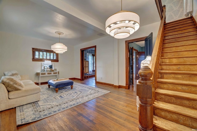 489 S Lincoln St, Orleans, IN 47452 - living area featuring stairway, wood finished floors, and baseboards