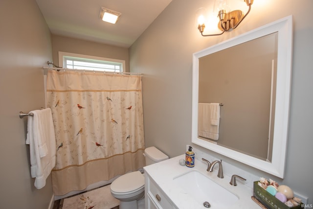 bathroom with toilet, vanity, and a shower with shower curtain