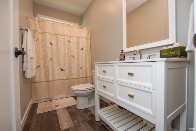 bathroom featuring wood finished floors, toilet, vanity, and a shower with shower curtain