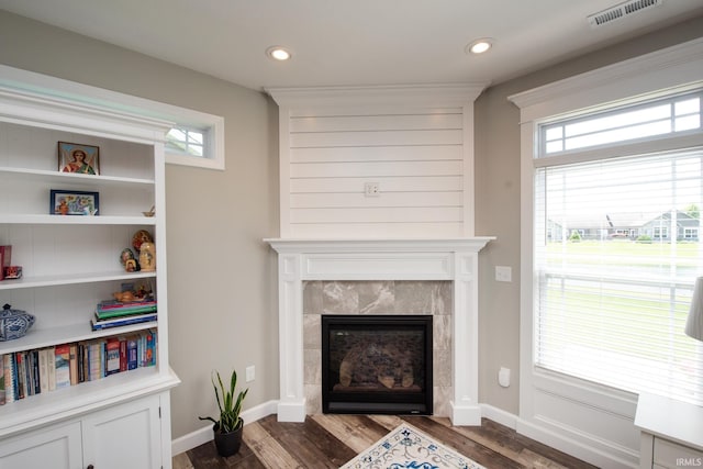 living room featuring wood finished floors, a tiled fireplace, plenty of natural light, and recessed lighting