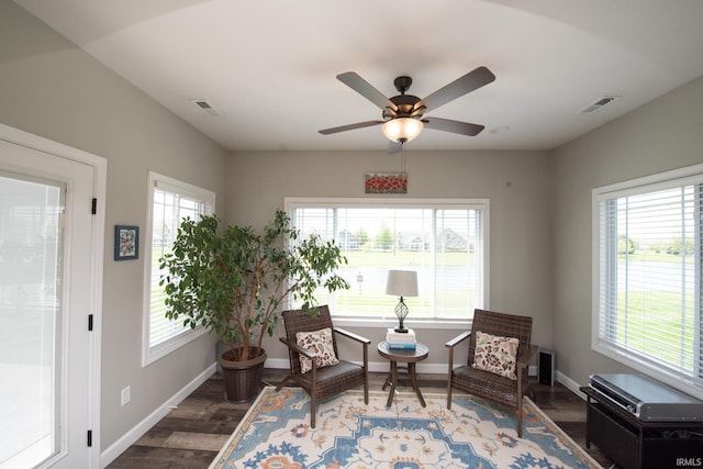 living area with wood finished floors, baseboards, and ceiling fan