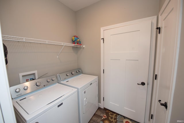 clothes washing area featuring independent washer and dryer and dark wood-type flooring