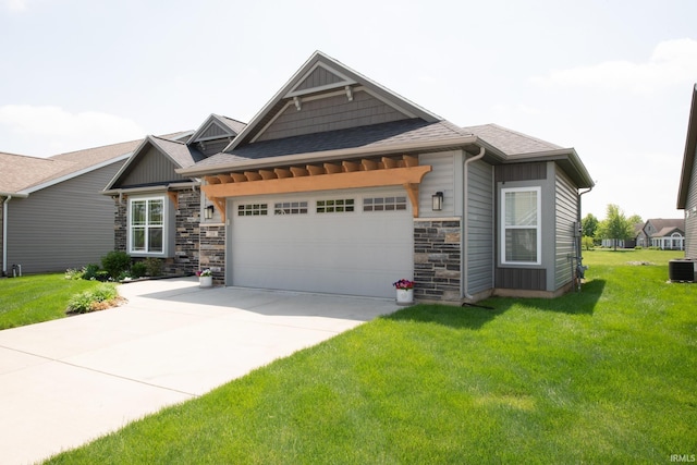 craftsman inspired home featuring a garage, concrete driveway, stone siding, and a front lawn