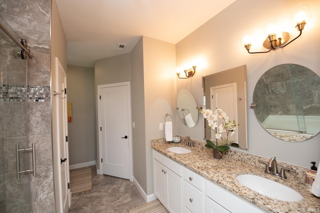 full bath featuring a tile shower, double vanity, baseboards, and marble finish floors