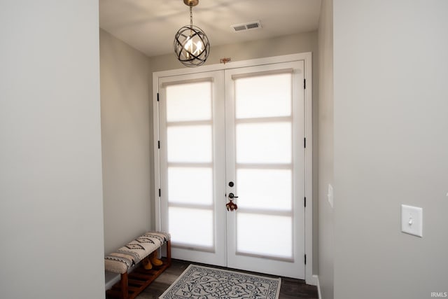 doorway with french doors and dark wood-style floors