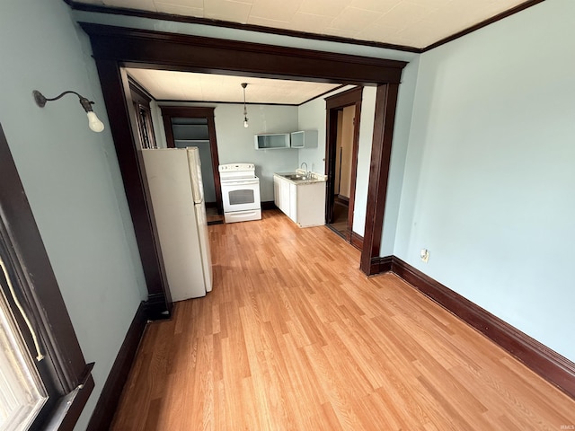 118 13th St, Logansport, IN 46947 - hall with ornamental molding, light wood-style flooring, a sink, and baseboards
