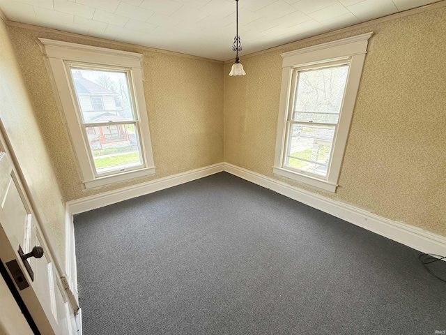 118 13th St, Logansport, IN 46947 - spare room featuring plenty of natural light, crown molding, dark carpet, and baseboards