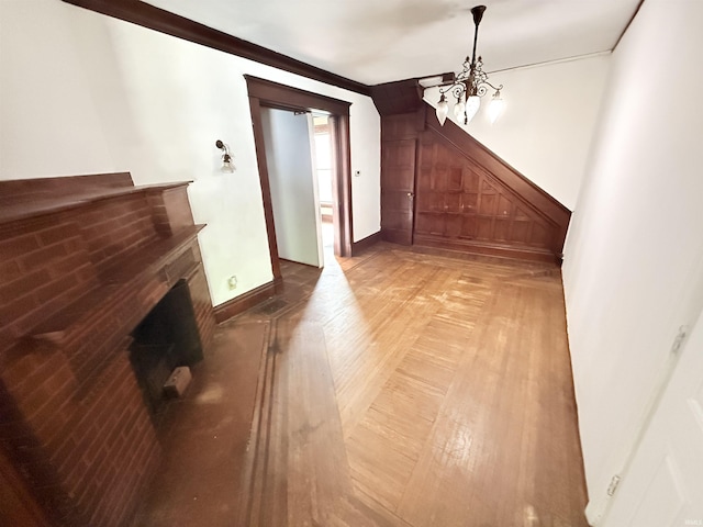 118 13th St, Logansport, IN 46947 - additional living space featuring a chandelier, a fireplace, baseboards, and light wood finished floors
