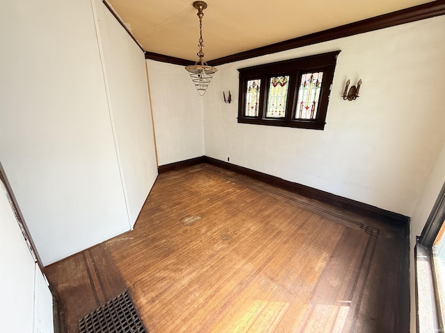 118 13th St, Logansport, IN 46947 - empty room with wood finished floors, crown molding, and baseboards
