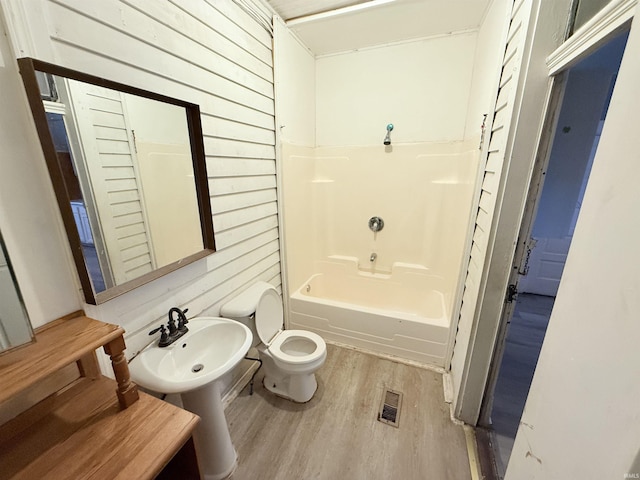 118 13th St, Logansport, IN 46947 - full bathroom with a sink, wood finished floors, toilet, tub / shower combination, and wood walls