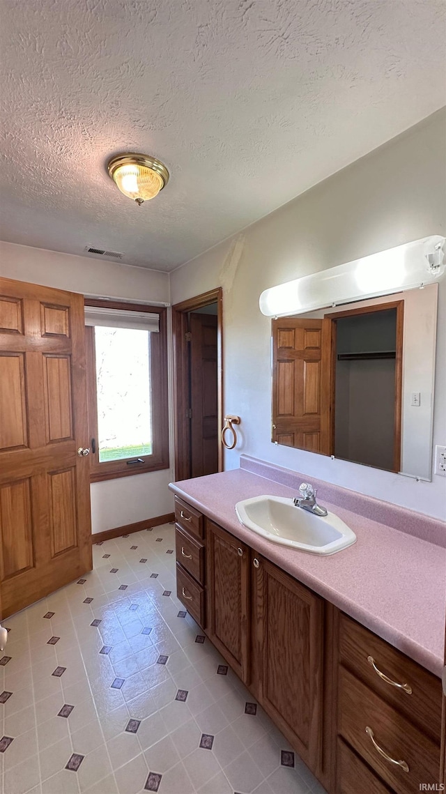 9081 N 725 E, Otterbein, IN 47970 - bathroom with vanity and a textured ceiling
