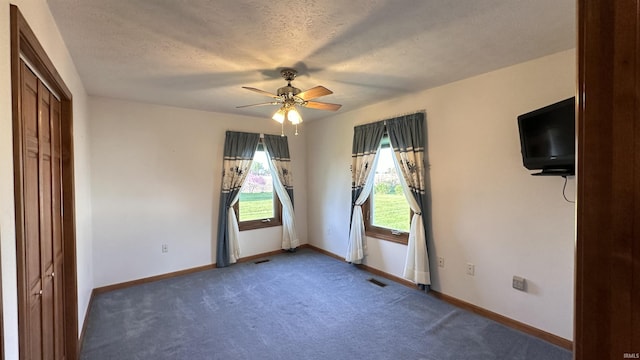 9081 N 725 E, Otterbein, IN 47970 - unfurnished bedroom with carpet flooring, baseboards, a ceiling fan, and a textured ceiling