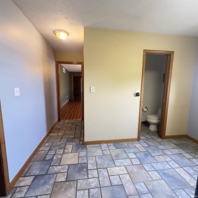 9081 N 725 E, Otterbein, IN 47970 - hall with light stone finish floors, baseboards, and a textured ceiling