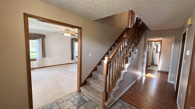 9081 N 725 E, Otterbein, IN 47970 - staircase with a ceiling fan, baseboards, and a textured ceiling