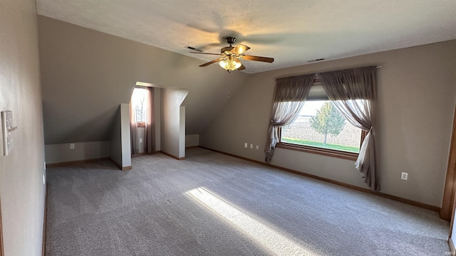 9081 N 725 E, Otterbein, IN 47970 - additional living space with ceiling fan, light colored carpet, baseboards, and lofted ceiling