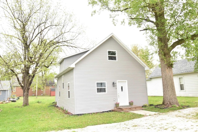 rear view of house with a lawn
