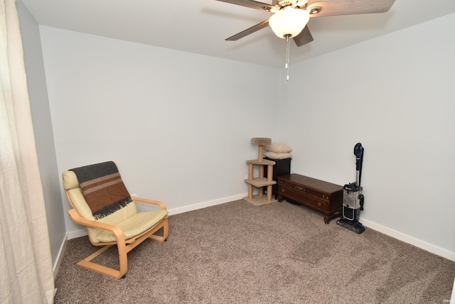 sitting room featuring carpet, ceiling fan, and baseboards