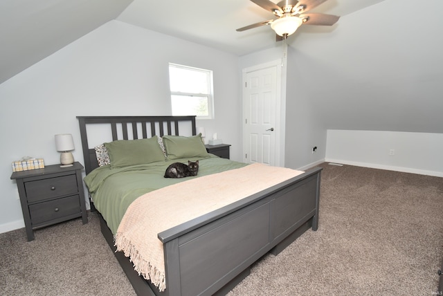 carpeted bedroom featuring vaulted ceiling, baseboards, and a ceiling fan