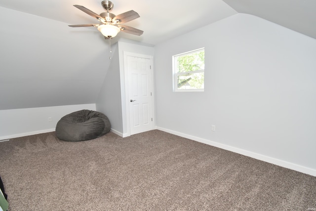 additional living space with lofted ceiling, carpet flooring, a ceiling fan, and baseboards