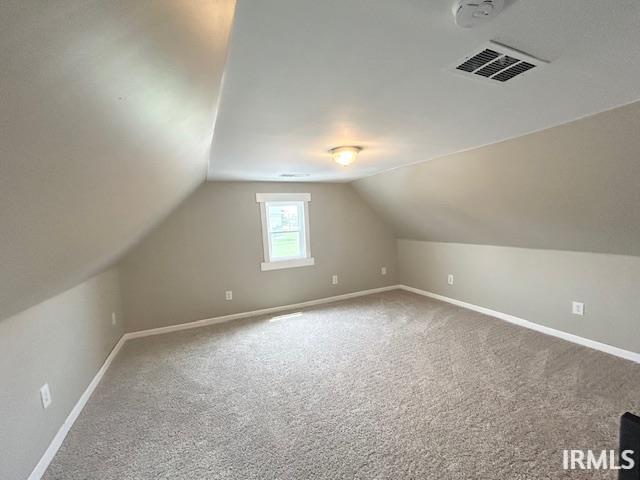 1023 W Franklin St, Evansville, IN 47710 - bonus room featuring carpet, baseboards, and lofted ceiling